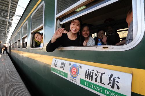 2月15日,几名旅客开心地登上昆明开往丽江的5652次列车,该趟列车搭载乘客近2400人。春节黄金周第三天,各地旅游者纷纷走出家门,参加娱乐休闲活动,虎年春节黄金周假日旅游进入高峰。新华社记者秦晴摄