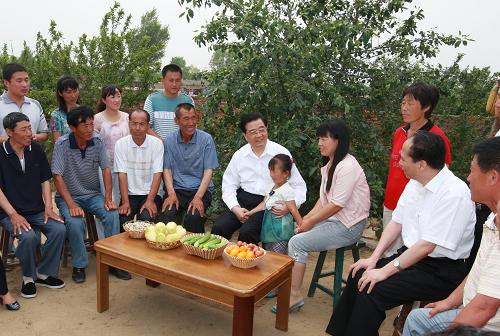 6月26日至28日,中共中央总书记、国家主席、中央军委主席胡锦涛在黑龙江省考察工作。这是胡锦涛在绥化肇东市五里明镇东升村同乡亲们亲切交谈。新华社记者 鞠鹏 摄
